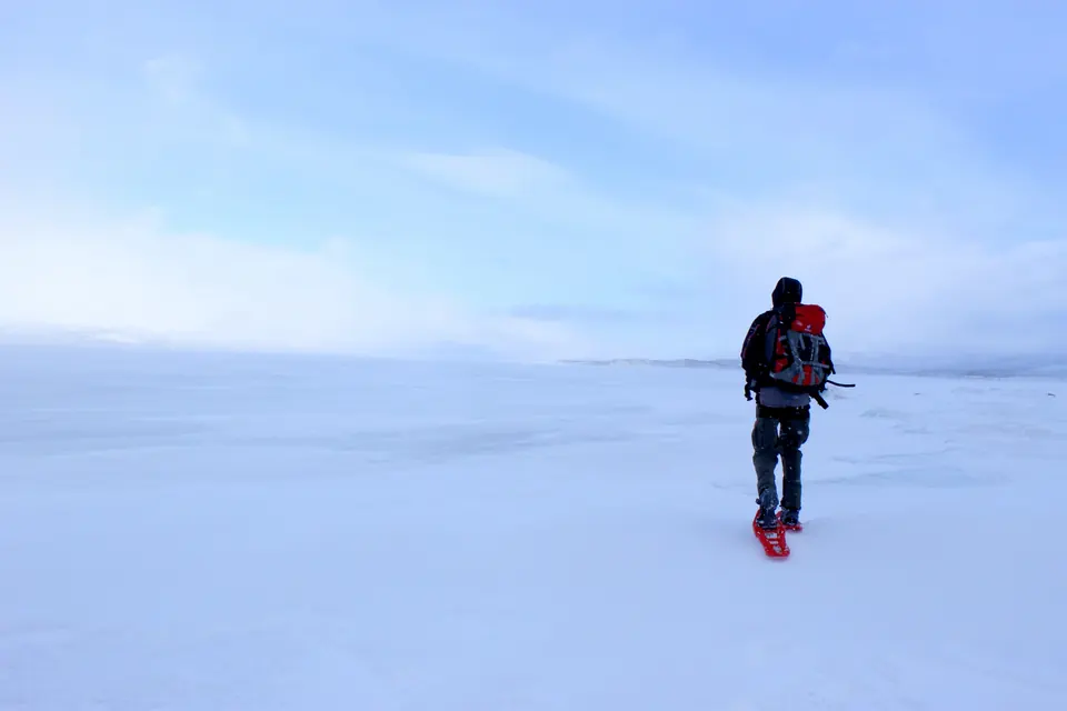 Hiking on the frozen Torneträsk lake, Sweden